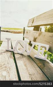 Love word over a wooden bench