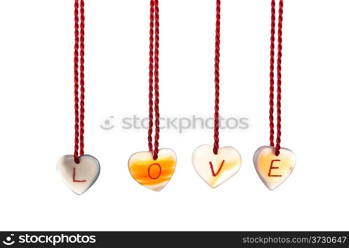 Love word spelled with agates that are engraved with white letters and are hung by ropes, isolated against white background