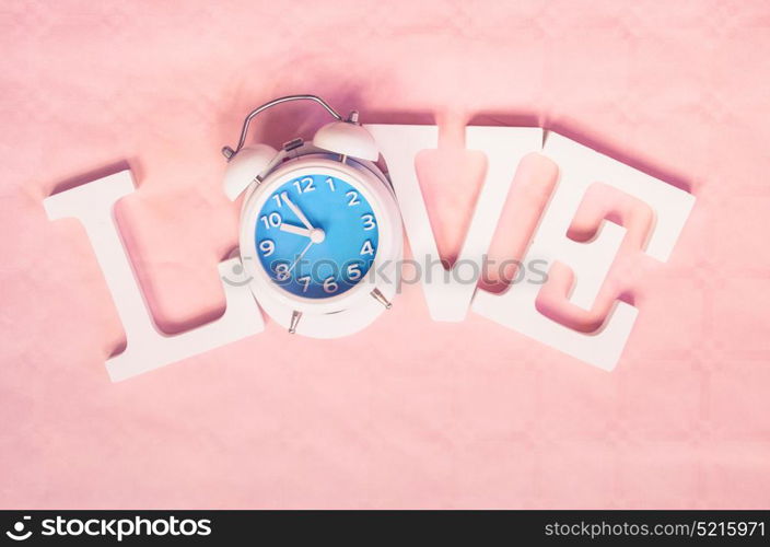 Love word with a clock as O