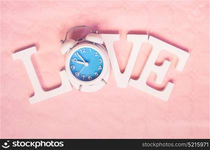 Love word with a clock as O