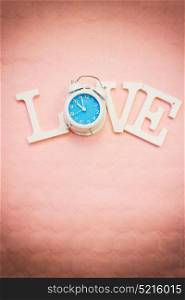 Love word with a clock as O