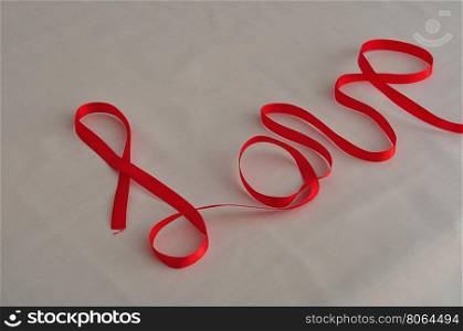 Love written with a red ribbon