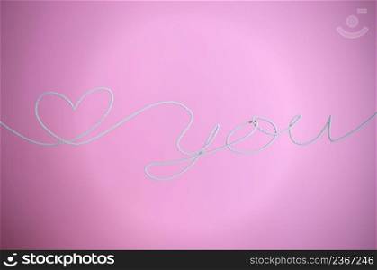 LOVE YOU and heart shape ROPE on pink background