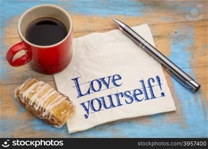 Love yourself advice - handwriting on a napkin with a cup of espresso coffee and cookie against grunge painted wood