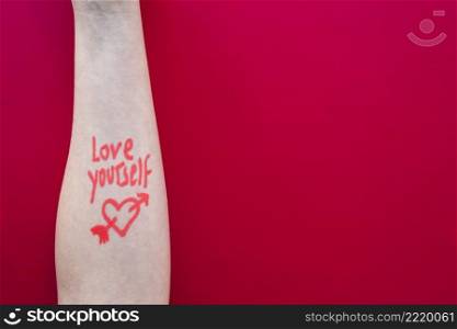 love yourself inscription arm