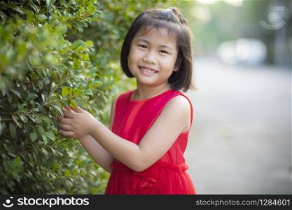 lovely asian girl wearing red skirt dress moving with happiness face outdoor