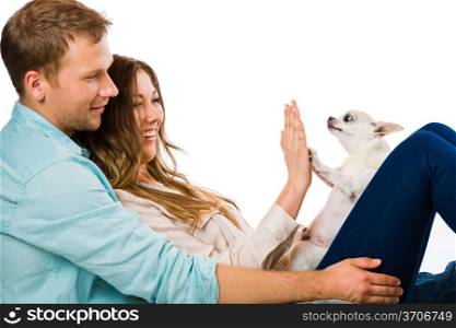 Lovely attractive couple and dog together, studio shot, white background