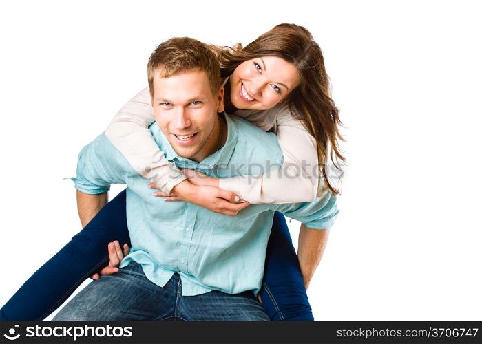 Lovely attractive couple on piggyback, studio shot, white background
