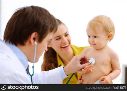Lovely baby being checked by a doctor using a stethoscope &#xA;
