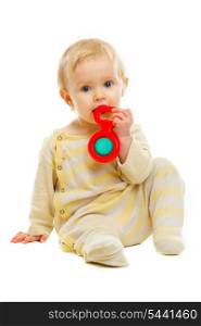 Lovely baby playing with rattle on floor isolated on white