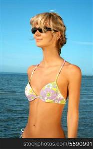 lovely blond in bikini standing in water