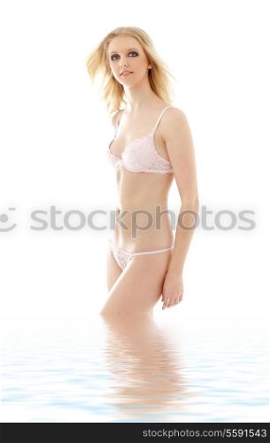 lovely blond in pink lingerie standing in water