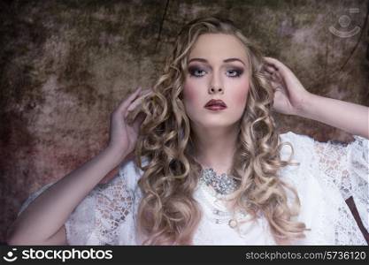 lovely blonde female with aristocratic style posing with long curly hair, stylish make-up, vintage elegant dress and precious necklace