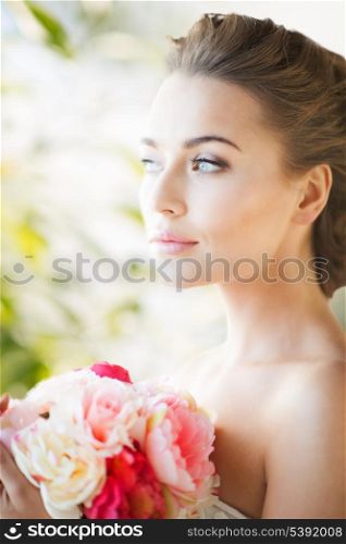 lovely bride with bouquet of flowers indoors