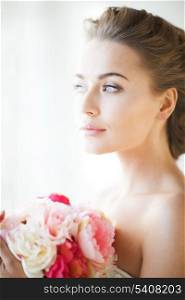 lovely bride with bouquet of flowers indoors.