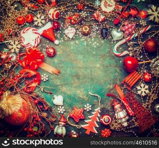Lovely Christmas background with holiday sweets , garland and red festive decoration, top view, frame. Vintage styled