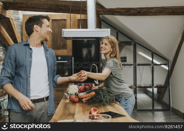 Lovely couple preparing food  in the kitchen