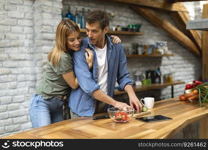 Lovely couple preparing food  in the kitchen