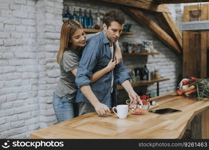 Lovely couple preparing food  in the kitchen