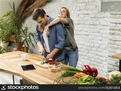 Lovely couple preparing food  in the kitchen