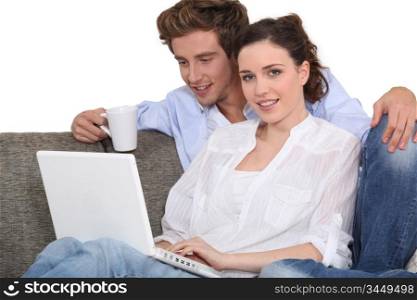 lovely couple with laptop indoors