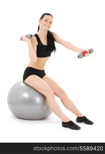 lovely fitness instructor with dumbbells on pilates ball