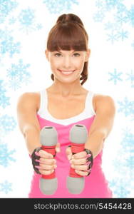 lovely fitness instructor with dumbbells over white