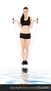 lovely fitness instructor with jump rope over white