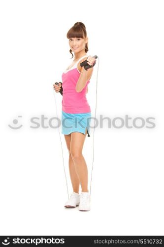 lovely fitness instructor with jump rope over white