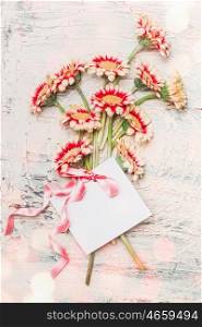 Lovely flowers bouquet with blank white card ,bow and bokeh on shabby chic background, top view