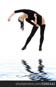 lovely girl in black leotard working out on white sand