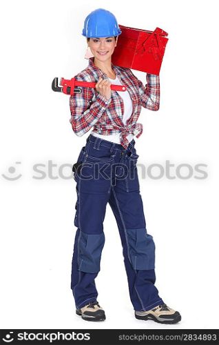 lovely girl in her twenties holding adjustable spanner and carrying toolcase