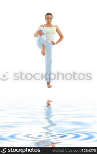 lovely girl practicing ashtanga yoga on white sand