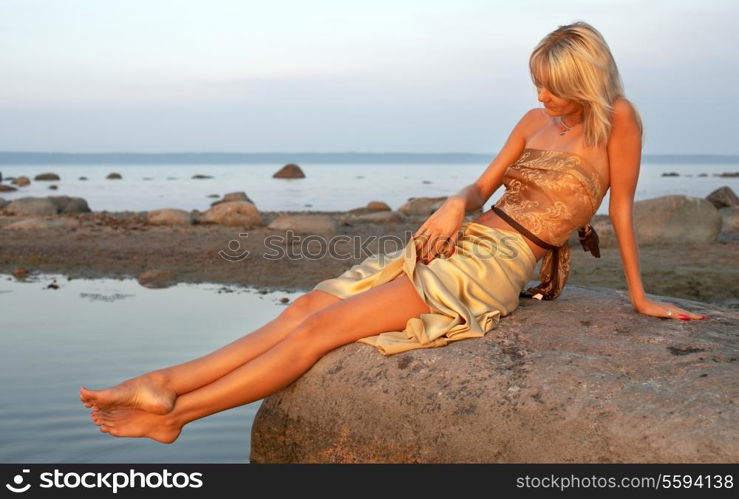 lovely girl relaxing on the rock
