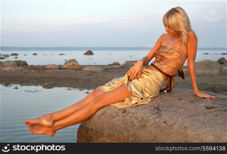 lovely girl relaxing on the rock