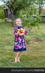 Lovely girl with apples in the hands in the garden on the farm.. Lovely girl with apples in the hands in the garden .