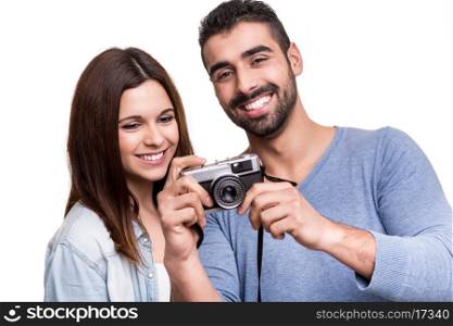 Lovely hipster couple taking retro camera photo