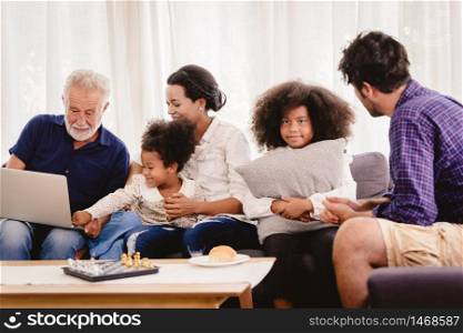 Lovely home happy family living together in living room father mother and grandfather playing with daughter mix race.