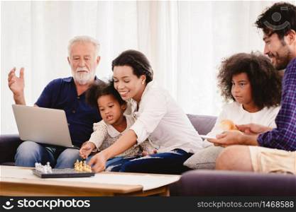 Lovely home happy family living together in living room father mother and grandfather playing with daughter mix race.