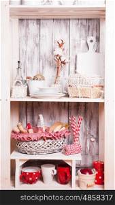 Lovely homeware and dishware in the kitchen at shabby chic style. Shelves in the rack