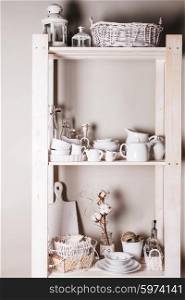 Lovely homeware and dishware in the kitchen at shabby chic style. Shelves in the rack