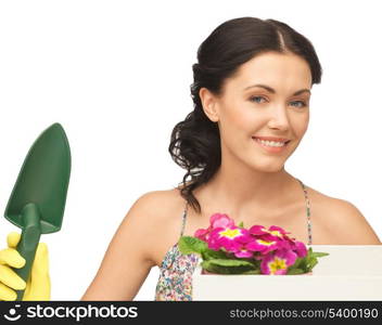 lovely housewife with flower in box and gardening trowel