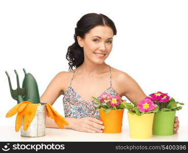 lovely housewife with flower in pot and gardening set