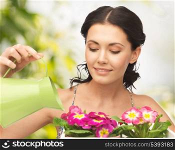 lovely housewife with flower in pot and watering can