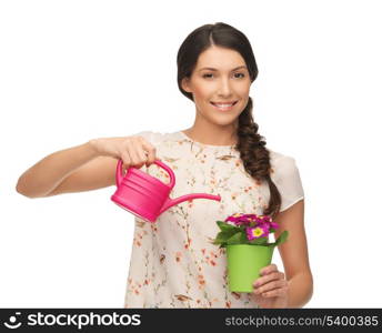 lovely housewife with flower in pot and watering can