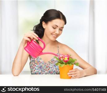 lovely housewife with flower in pot and watering can