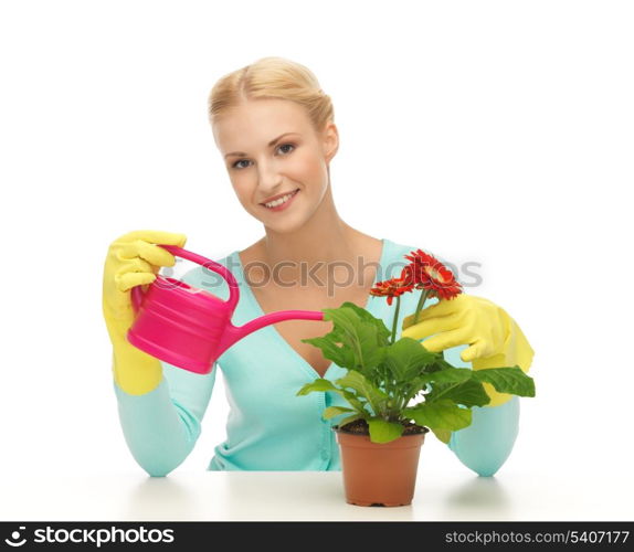 lovely housewife with flower in pot and watering can