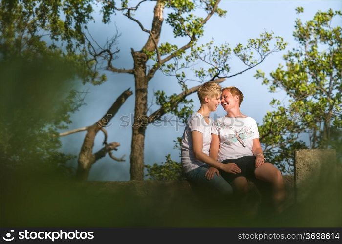Lovely lesbian couple together in privacy, sunny summer day