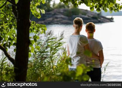 Lovely lesbian couple together, sunny day, sea on background