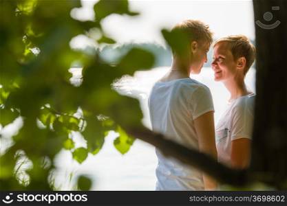 Lovely lesbian couple together, sunny day, sea on background